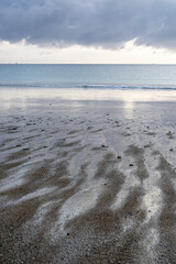 View of the sandy beach at low tide of Saint-Cast-Le-Guildo in summer in Côtes d'Armor, Brittany, France