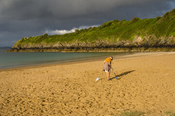 Man searching for metals on the beach at Saint-Cast-Le-Guildo in Brittany, France