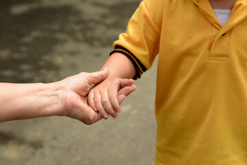 An adult's hand holds the hand to guide the person. Concept of love, security, protection, and...