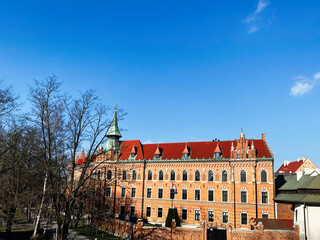 Obraz premium Historic brick building in Krakow Poland with a blue sky background. Higher Theological Seminary of the Archdiocese.