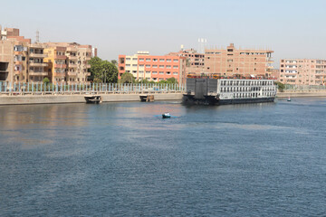 Fototapeta premium View of cruise ships queuing to pass through the Esna Lock on the River Nile, Egypt