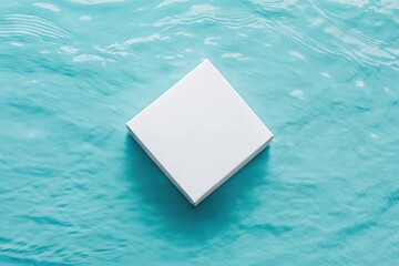 White box floating on blue water surface in serene setting near the shore