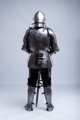 Naklejka premium Full Suit of Fourteenth Century Knight's Plate Armor. Impressive display of medieval protective gear, including helmet, breastplate, gauntlets, and greaves