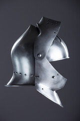 Medieval Knight's Polished Steel Armet Helmet. Detailed close-up of a shiny, historical piece of...