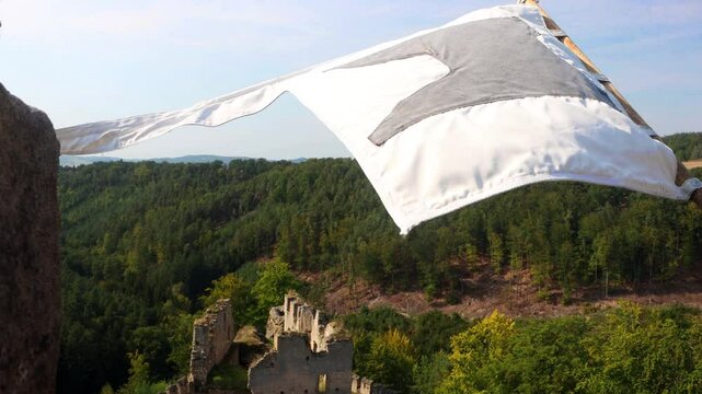 View from the tower of the medieval castle with a flying replica of the historical banner, Czechia