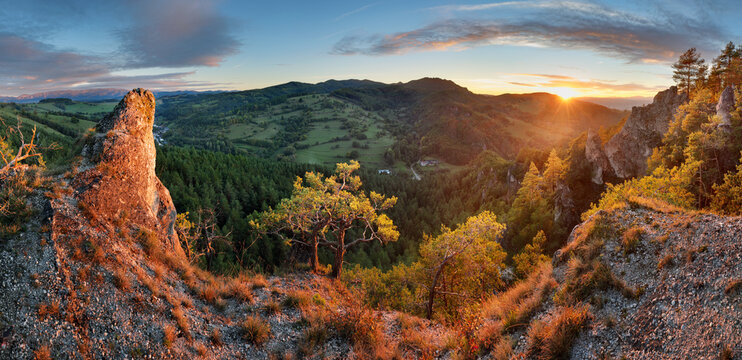 Panoramic view of mountain range under colorful blue and orange sundown in Slovakia. Rocky forest landscape