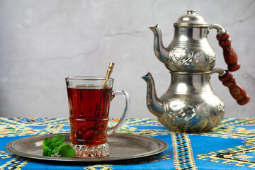 still life with traditional turkish tea in drinking glasses and silver traditional silver tea pot