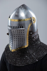 Steel Helmet with Perforated Visor. Medieval head protection featuring brass trim and leather straps.