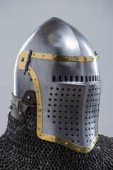 Steel Helmet with Perforated Visor. Medieval head protection featuring brass trim and leather straps.
