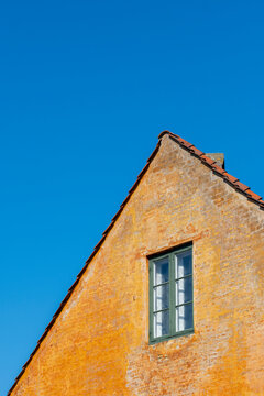Colorful historic houses in Nyboder neighborhood of Copenhagen, with clear sky and clean lines, ideal for urban architecture and real estate projects.