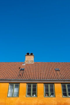 Classic Copenhagen homes in Nyboder, with bold colors and clean geometry, ideal for editorial or commercial stock needs highlighting Danish urban design.