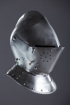 Shiny Silver Medieval Armet Helmet with Visor. This polished silver armet features a hinged visor and bevor, offering full head protection in medieval style.