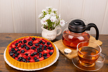 Berry pie and tea on the table. Dessert for tea. Berry pie. Strawberry pie