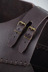 Close-up of Leather Straps and Rivets on Brown Cuirass. Detailed view of the fastenings on medieval torso armor.