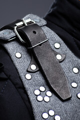 Close-up of Brigandine Armor Leather Straps and Rivets. Detailed view of the gray brigandine showing the leather straps, buckles, and metal rivet construction.