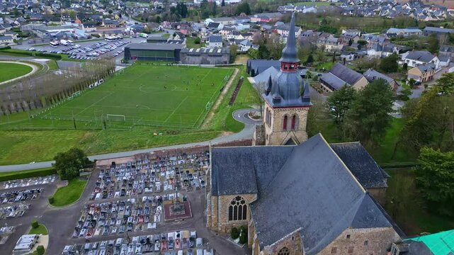 Saint-M&eacute;en-le-Grand, abbey church and cemetery, Brittany in France. Aerial drone backward and tilt up