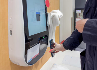 Self-checkouts or self-service checkouts,man paying for the purchases  in supermarkets