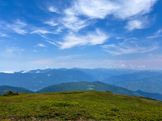 Mountain landscapes background with mountain ranges in Georgia. Green slopes in summer in Adjara region. Travel in Georgia with scenic nature and eco tourism