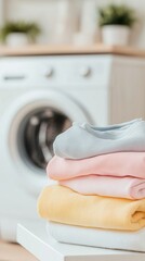 Washing machine in a bright laundry room with neatly stacked colorful towels after a refreshing laundry session