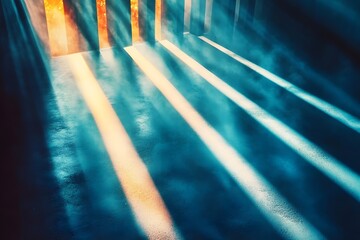 Obraz premium Sunlight streams through vertical openings casting bright rays on a textured blue surface creating contrast