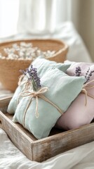 Soft fabric sachets with lavender adorn a rustic tray next to a woven basket filled with dried flowers in a cozy, sunlit home setting