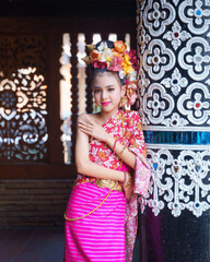 Beautiful traditional Thai dress, Lanna. Pretty Asian women wearing ancient native Northern Thai dress costumes according Thai culture and tradition at the ancient temple of Chiang Mai, Thailand.