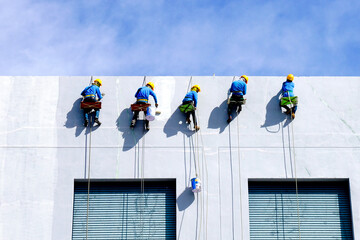 Painters Hanging from a Rope, Painting the Building Exterior Wall.