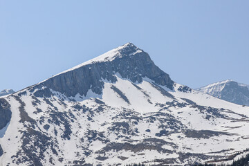 Snowy mountaintop peak in Banff National Park under cloudless sky
