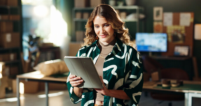 Tablet, search and woman in creative small business with ecommerce, networking and dropshipping. Smile, designer and entrepreneur in office on digital app, online order management or delivery boxes