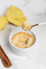 Apple crumble with streusel, light table. Morning breakfast.