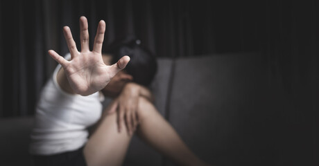 Stop Violence Against Women. Woman Raises Hands to Stop Violence by Sitting on Sofa. Stop Violence