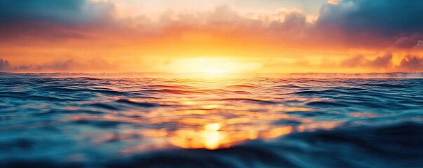 Fototapeta premium Sunset over the ocean scenic view with vibrant sky and dramatic dusk concept. Stunning sunset over calm ocean waves in vibrant colors.
