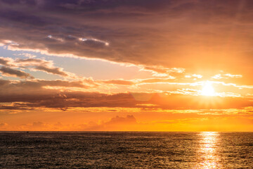 Fototapeta premium scenic view at beautiful morning beach coastline with orange sand, blue sea water of gulf and beautiful cloudy sky. Nature landscape of wallpaper and backgeound