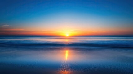 Fototapeta premium Sunset over the ocean scenic view with vibrant sky and dramatic dusk concept. Breathtaking sunset over calm ocean waves reflecting vibrant colors.