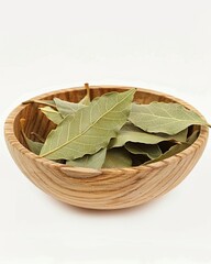 Fototapeta premium A wooden bowl containing bay leaves on a white background, high-resolution photography, realistic,