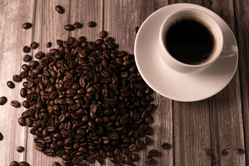 Coffee beans view from above. A cup of espresso coffee. Aromatic coffee