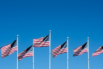 Obraz premium A row of American flags are flying high in the sky. The flags are all different sizes and colors