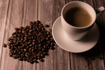 A cup of hot coffee. Coffee and coffee beans. Dark background. Top view