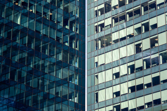 Dense reflections on high-rise buildings with cool color palette and layered glass. Excellent for architecture, business or financial district stock needs.