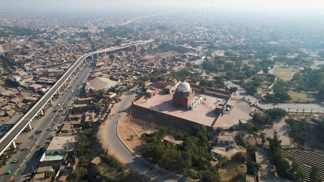 Drone view of Multan showing Bahauddin Zakariya shrine, metro route, and dense urban surroundings. Multan,