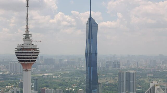 Drone view of Menara KL and Warisan Merdeka Tower in Kuala Lumpur, Malaysia