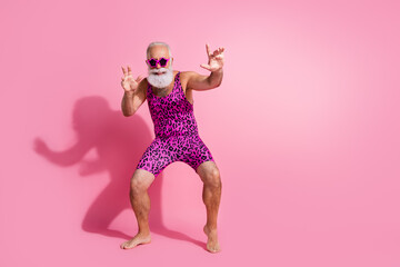 Full body photo of positive old man enjoy discotheque wear glamour leopard print overall isolated pink color background