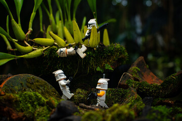 Naklejka premium Depok, Indonesia - April 1, 2025: Lego toys photography, 1st phase clone troopers in dark forest covered with moss, with bokeh background