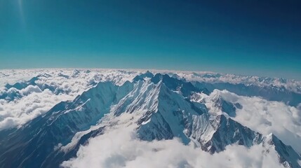 Fototapeta premium Majestic Aerial View of Snow-Capped Himalayan Peaks Soaring Above a Sea of Clouds Under a Vibrant Sky