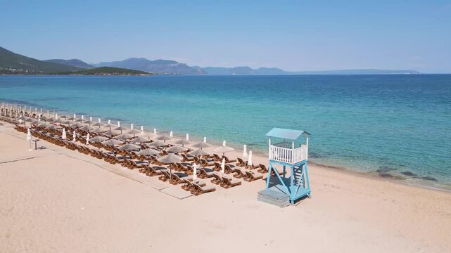 Sunbeds on the Sandy Shore of Alikes Beach, Chalkida, with Crystal Blue Waters