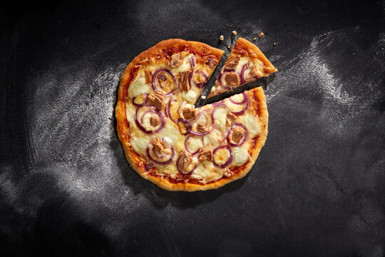 Pizza mit Thunfisch (St&uuml;ck) , roten Zwiebeln und K&auml;se &ndash; herzhaft und klassisch serviert