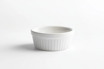 A small white ceramic dish sitting on a white surface
