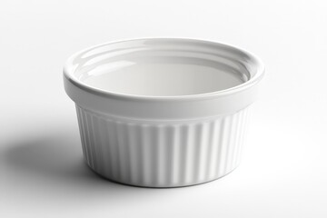 A white ceramic ramekin pot placed on a plain white surface