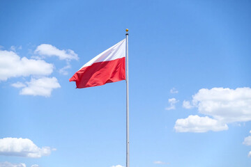 red and white flag flying high in the sky