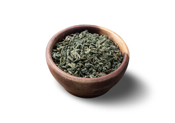 Dried green tea leaves on a bowl isolated over white background